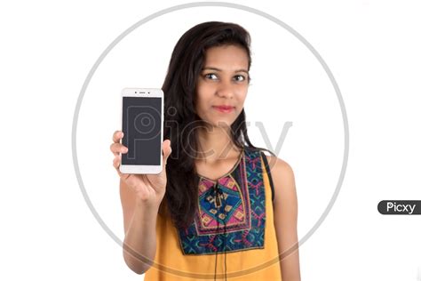 Image Of Young Indian Girl Showing Empty Mobile Or Smartphone Screen On