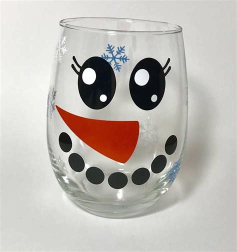 Snowman Face Wine Glass With Blue And White Snowflakes Scattered Around