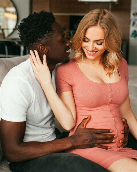 A Man And Woman Sitting On A Couch Cuddling Each Others Butts