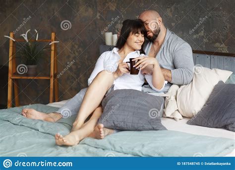 Cute Young Couple Drinking Morning Coffee Lying In Bed. Love And Relationships, Husband And Wife ...