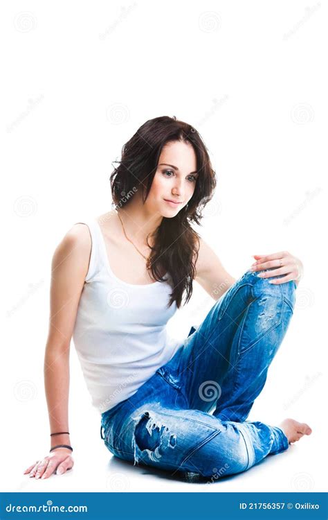 Pretty Woman In Blue Jeans Sitting On White Floor Royalty Free Stock