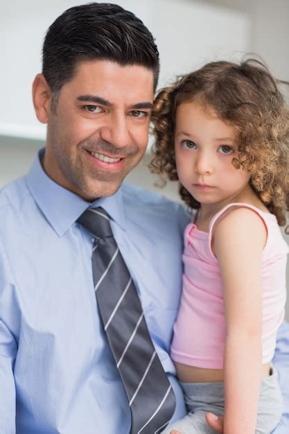 Premium Photo Smiling Well Dressed Father Carrying His Daughter