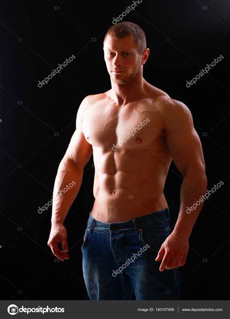 Healthy muscular young man. Isolated on black background — Stock Photo © lenetssergey #140107456