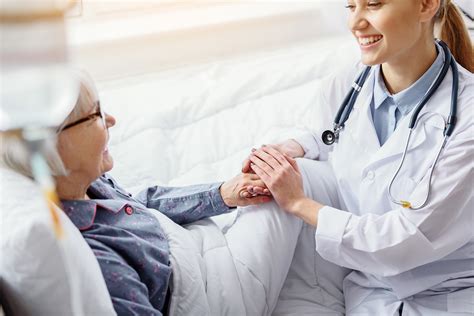 Smiling patient keeping hand of doctor | Virginia Women's Center