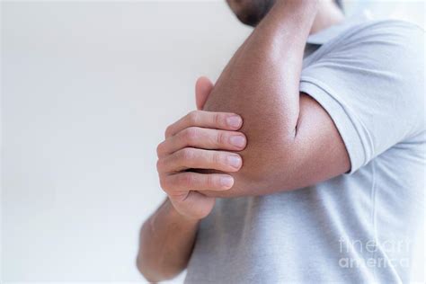 Man Touching His Elbow In Pain Photograph By Science Photo Library Pixels