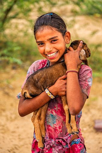 Portrait Of Young Indian Girl Holding Goat Village Near Jodhpur Stock