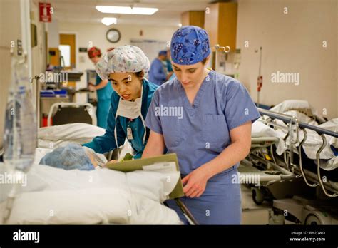 Dressed In Scrubs A Woman Surgeon And Her Circulating Nurse Check