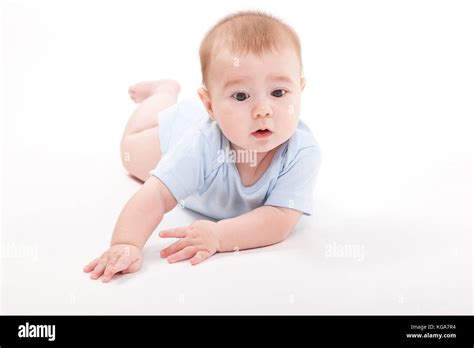 Baby In The Body Lying On His Stomach On A White Background And Stock