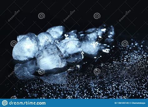 Melting Ice Cubes And Water Drops On Black Background Stock Image