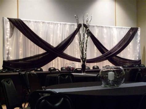 Black Swags On Fabric Backdrop Behind Head Table At