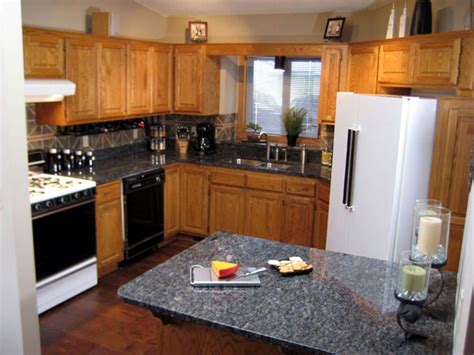 Concrete countertops are left and center, with a black granite counter over the black refrigerators. Granite Kitchen Countertop Tips | DIY