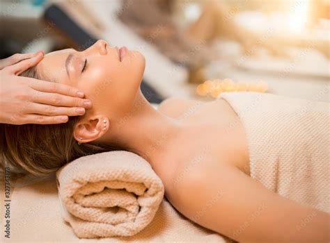 Calm Caucasian Woman Lying On Back With Closed Eyes Get Massage On Head By Professional Spa