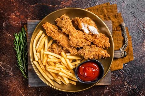 Fried Breaded Chicken Tender Strips With French Fries And Tomato
