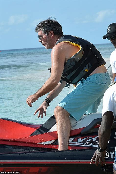simon cowell hits barbados beach with swimsuit clad lauren silverman and eric daily mail online