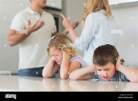 Children Covering Ears While Parents Arguing Stock Photo Alamy