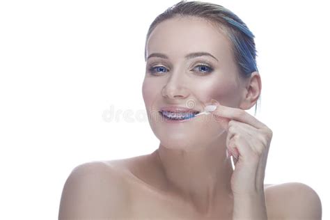 Caucasian Female With Teeth Braces And Smooth Skin Using Tooth Brushes