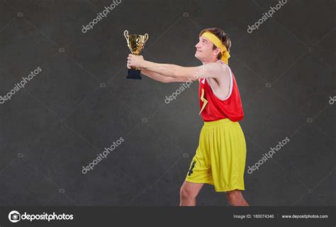 Funny Thin Guy In Sports Clothes With A Championship Cup In His Stock