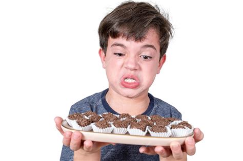 premium photo 9 year old brazilian holding a tray with several brazilian fudge balls and