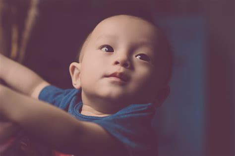 Close Up Photography Of Baby Looking Up · Free Stock Photo