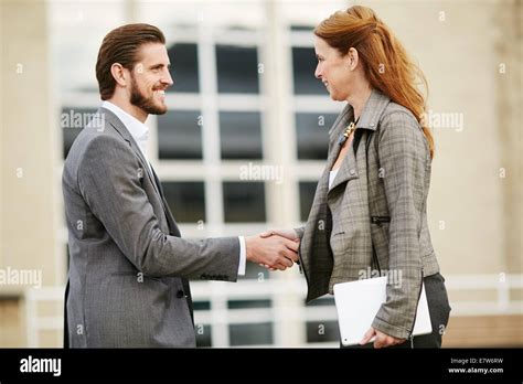 Two Business People Greeting Each Other Stock Photo Alamy