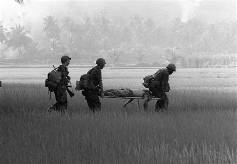 Us Troops Carry The Body Of A Fellow Soldier Across A Rice Paddy For