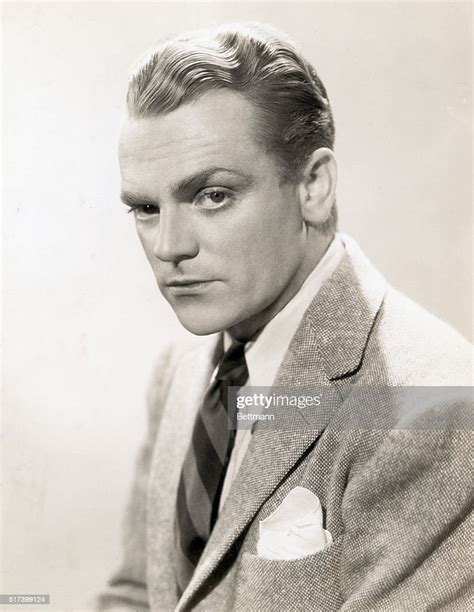 Picture Shows Actor James Cagney Wearing A Suit And Seated Slightly