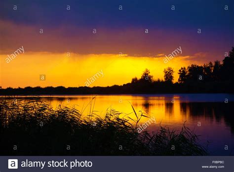 Red Sunset Over Lake Stock Photo Alamy