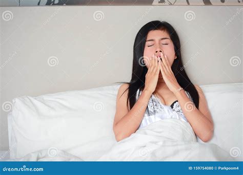 Young Woman Yawning Before Go To Sleep In Bedroom Stock Photo Image