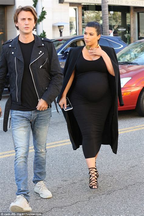 Kim Kardashian Steps Out In Heels As Pregnancy Is Starting To Make Her