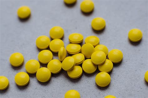 Yellow Medication Pills On Gray Surface · Free Stock Photo