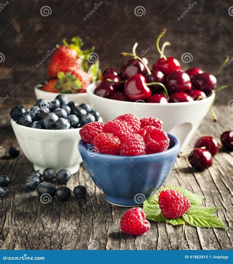 Fresh Berries In Bowls On Wooden Background Stock Image Image Of