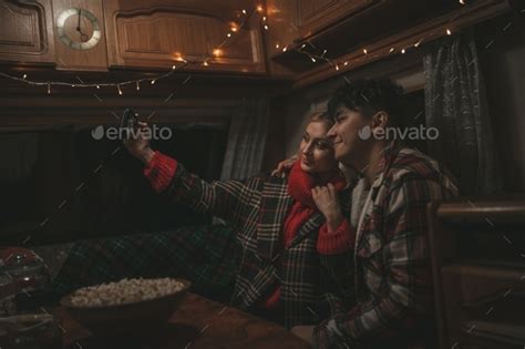 Candid Authentic Happy Married Couple In Love Taking Selfie From Mobile Phone At Night Motorhome