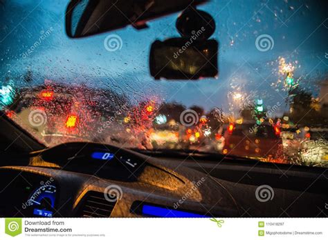 Abstract Blurred Rain Drops On Car Glass Window With Bokeh Traffic