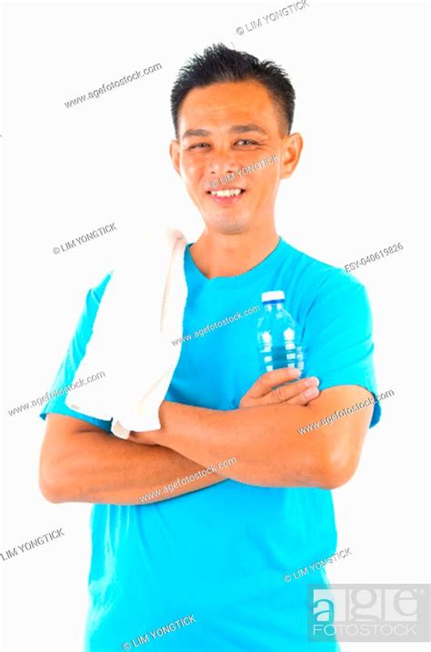 Southeast Asian Fitness Man Holding Water Bottle And Towel After Training Isolated On White