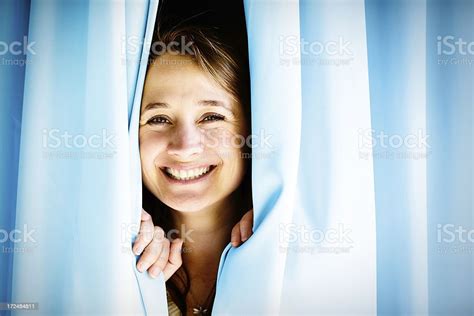 How Nice To See You Pretty Blonde Peeks Through Curtains Stock Photo