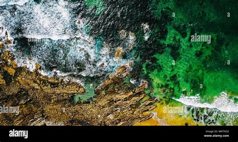 Aerial View From Flying Drone Of Ocean Waves Crushing On Rocky Beach