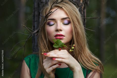 Attractive Girl With A Little Bush Of Strawberries In Her Hands Stock