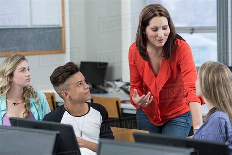 Teacher Explaining To High School Students In Class Stock Photo