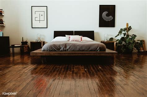 A Bed Sitting On Top Of A Wooden Floor In A Bedroom