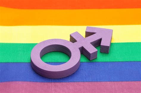 premium photo violet transgender symbol on the background of the rainbow flag of the lgbt pride