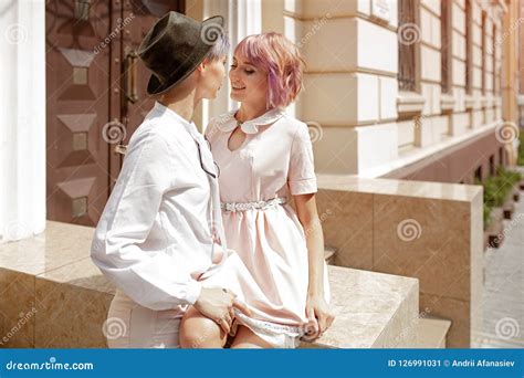 two girls touching each other near the stairs of the building in the city stock image image of