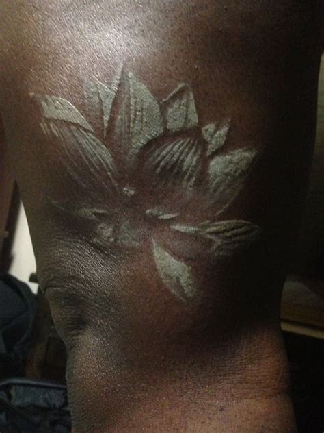 Nice Lotus White Ink Tattoo On Knee Tattoos For Black Skin White Tattoo On Dark Skin White