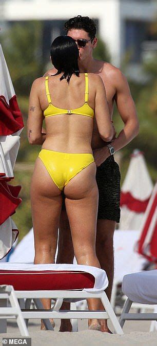 Dua Lipa Showcases Her Slender Figure In A Yellow Bikini On Beach Date