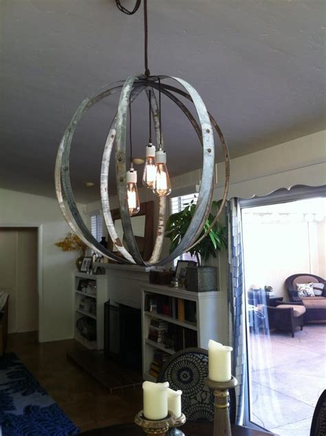 Glass lanterns can be filled with fairy lights or solar lights. Homemade light fixture out of wine barrels and edison ...