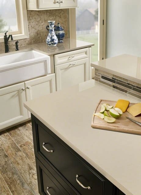 Quartz countertops are often made quartz is a crystal like mineral that comes in a variety of colors from clear, milky white and smoky grey to pale shades of purple, pale yellow and pale pink. White Kitchen Cabinets With Beige Quartz Countertops ...