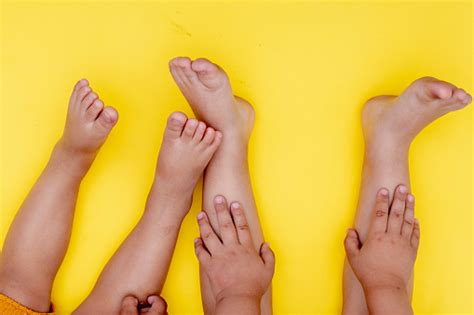 Kids Legs On Yellow Paper Flat Lay Childhood Concept Stock Photo