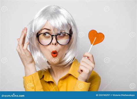 Cheerful Glamorous Woman With A Lollipop In Her Hands Model Stock Image