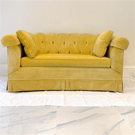 The symmetrical design and tapered legs give it a vintage spin, while the soft velvet fabric will offer a cozy feel for everyday use. Vintage 1950s Hollywood Regency Tufted Yellow Velvet Loveseat | Chairish