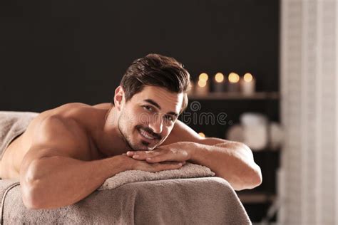 Handsome Man Relaxing On Massage Table In Spa Salon Space For Text