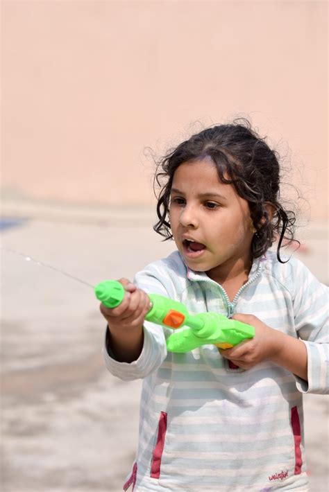 Cute Little Girl Playing With Water Gun Free Image By Amit Dabas On